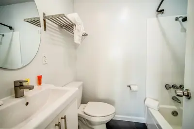 a bathroom with a sink and a toilet and a mirror at AIR Venice on the Beach in Los Angeles