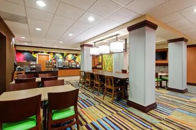 a restaurant with tables and chairs and a bar at Fairfield Inn & Suites - Los Angeles West Covina in West Covina