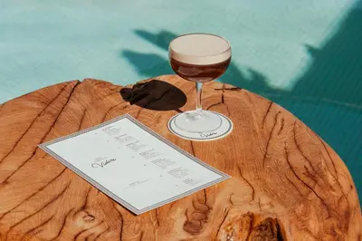 a glass of wine sitting on top of a piece of wood at Kimpton Hotel Wilshire by IHG in Los Angeles