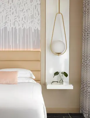 a bedroom with a bed and a pendant light at Kimpton Hotel Wilshire by IHG in Los Angeles