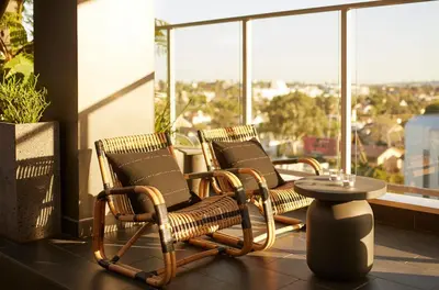 two chairs and a table on a balcony at Kimpton Hotel Wilshire by IHG in Los Angeles