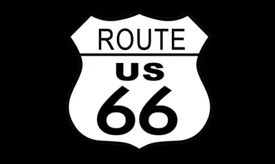 a white and black sign that reads route us at Economy Inn Barstow in Barstow