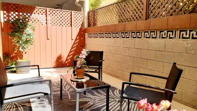 a patio with two chairs and a table with flowers on it at Double Suite Santa Monica - Free Parking in Santa Monica