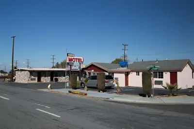 an empty street in a small town with a motel at Boron Motel in Boron