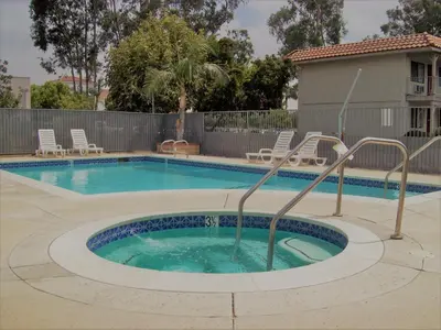 a swimming pool with a slide in the middle at Regency Inn in Norco