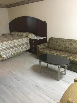 a living room with a couch and a coffee table at Regency Inn in Norco