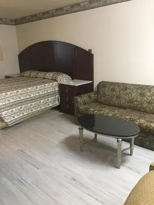 a living room with a couch and a coffee table at Regency Inn in Norco