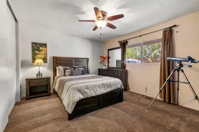 a bedroom with a bed and a ceiling fan at Piece of Paradise in Big Bear Lake