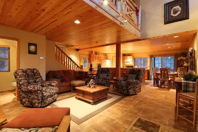 a living room with couches chairs and a table at Summit Ski-Inn Ski-Out in Big Bear Lake