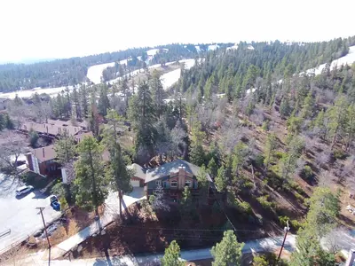 an aerial view of a house in the woods at Summit Ski-Inn Ski-Out in Big Bear Lake