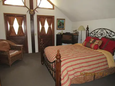 a bedroom with a bed and a chair at Miller's Outpost in Big Bear Lake