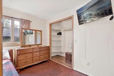 a bedroom with a dresser and a mirror at Lodge House-Family Cabin with Pool Table by Big Bear Vacations in Big Bear Lake