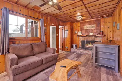 a living room with a couch and a fireplace at Little Pines Couples Lakeside Cabin by Big Bear Vacations in Big Bear Lake