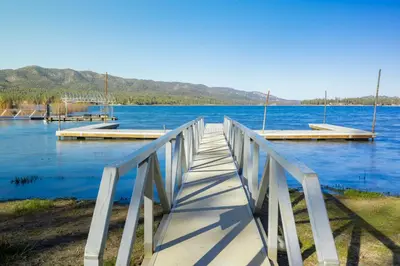 a wooden bridge over a large body of water at Big Pines Couple Lakeview Studio Cabin by Big Bear Vacations in Big Bear Lake