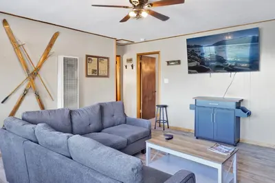 a living room with a couch and a table at Lakefront Family Cabin by Big Bear Vacations in Big Bear Lake