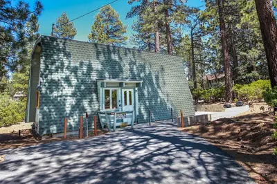 a small house in the middle of a road at Switzerland Ski Chalet-845 by Big Bear Vacations in Big Bear Lake