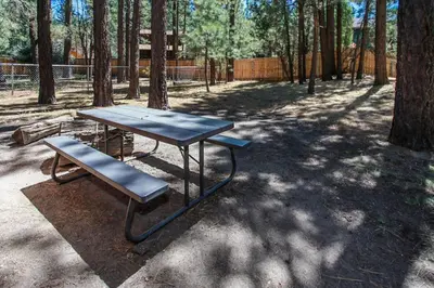 a picnic table and a bench in a park at Avalon Hide Out-1336 by Big Bear Vacations in Big Bear Lake