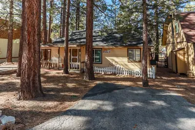 a house in the woods with trees at Pines 23-1438 by Big Bear Vacations in Big Bear Lake