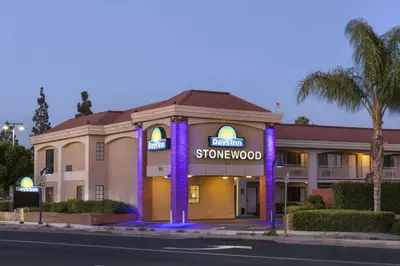 a hotel with purple lights in front of a building at Days Inn by Wyndham Downey in Downey