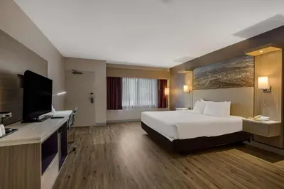 a hotel room with a bed and a flat screen tv at Best Western Diamond Bar Hotel & Suites in Diamond Bar
