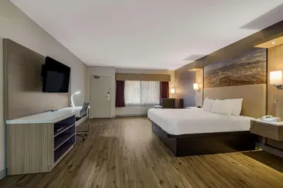 a hotel room with a bed and a flat screen tv at Best Western Diamond Bar Hotel & Suites in Diamond Bar