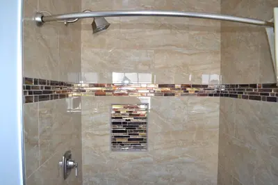 a shower stall with a glass door with a shower at Rex Motel in Ventura