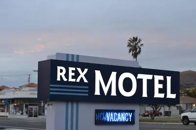 a sign for a motel on the side of a street at Rex Motel in Ventura