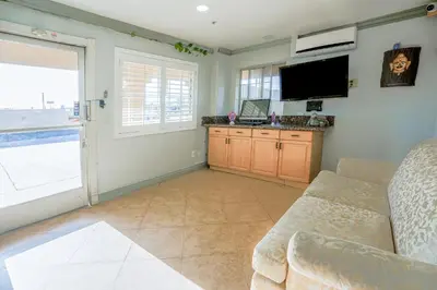 a living room with a couch and a flat screen tv at Day & Night Inn in Hesperia