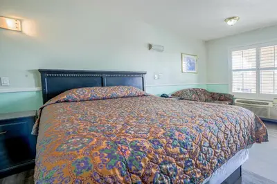 a bedroom with a large bed and a window at Day & Night Inn in Hesperia