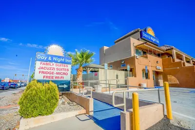 a building with a sign in front of it at Day & Night Inn in Hesperia