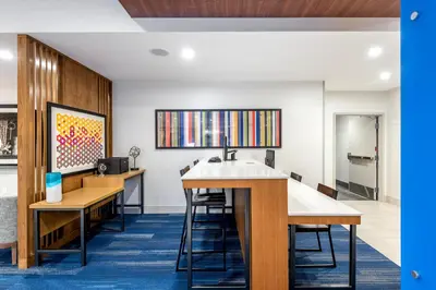 an office with a desk and a sink in a room at Holiday Inn Express & Suites Santa Ana - Orange County by IHG in Santa Ana