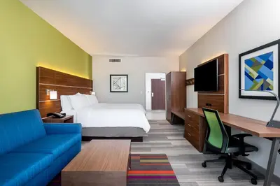 a hotel room with a bed and a desk at Holiday Inn Express & Suites Santa Ana - Orange County by IHG in Santa Ana
