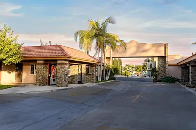 an empty parking lot in front of a building at Hyland Inn Brea in Brea