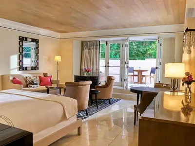 a bedroom with a bed and a living room at Hotel Bel-Air - Dorchester Collection in Los Angeles