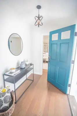 a blue door in a room with a table and a mirror at Enchanting Sherman Oaks Home With Pool permit #HSR two five zero zero 3222 in Sherman Oaks