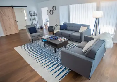 a living room with a couch and a table at Enchanting Sherman Oaks Home With Pool permit #HSR two five zero zero 3222 in Sherman Oaks
