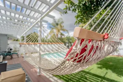 a hammock on a patio with a house at Enchanting Sherman Oaks Home With Pool permit #HSR two five zero zero 3222 in Sherman Oaks