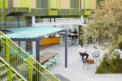 a man sitting on a chair in the middle of a building at Mayumi in Los Angeles