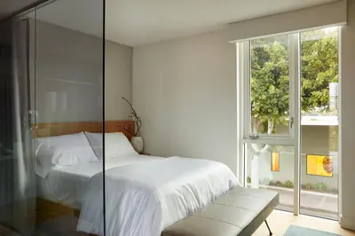 a bedroom with a white bed and a window at Mayumi in Los Angeles