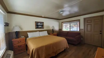 a bedroom with a bed and a couch at Kernville Inn in Kernville