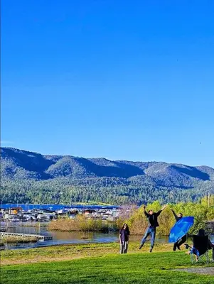 a group of people jumping in the air in a field at Big Bear Frontier in Big Bear Lake
