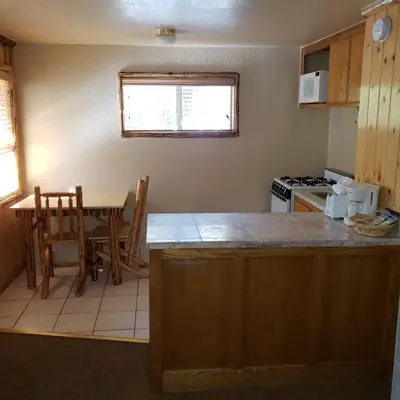 a kitchen with a table and a counter top at Big Bear Frontier in Big Bear Lake