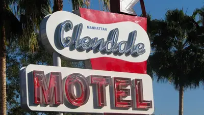 a sign for adonalds motel with palm trees in the background at Motel 6 Glendale CA Pasadena Burbank Los Angeles in Glendale