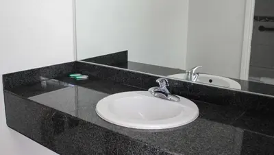 a bathroom counter with a sink and a mirror at Motel 6 Glendale CA Pasadena Burbank Los Angeles in Glendale