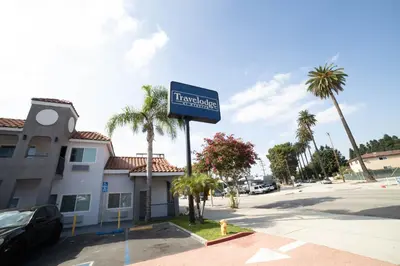 a sign for a hotel in a parking lot at Travelodge by Wyndham Whittier in Whittier