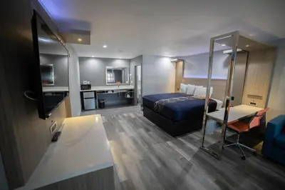 a hotel room with a bed and a desk at Travelodge by Wyndham Whittier in Whittier