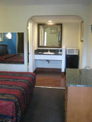 a hotel room with a bathroom with a sink at Sunshine Motel in San Bernardino