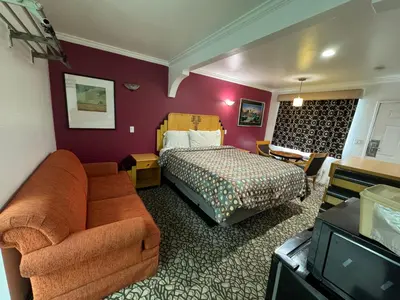 a hotel room with a bed and a couch at El Dorado Motel in Gardena