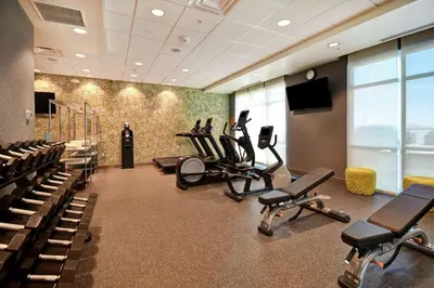 a gym with treadmills and exercise bikes in a room at Home2 Suites by Hilton Victorville in Victorville