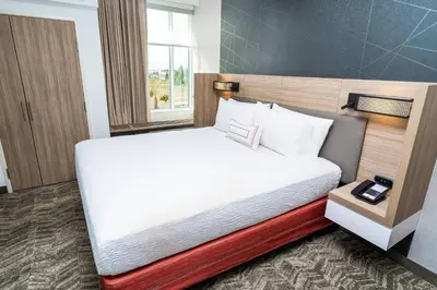 a bed in a hotel room with a white bed at SpringHill Suites by Marriott Ontario Airport/Rancho Cucamonga in Ontario